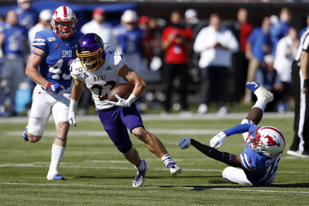 East Carolina receiver Tyler Snead (22) advances the ball after SMU safety Chace Cromartie, rig ...