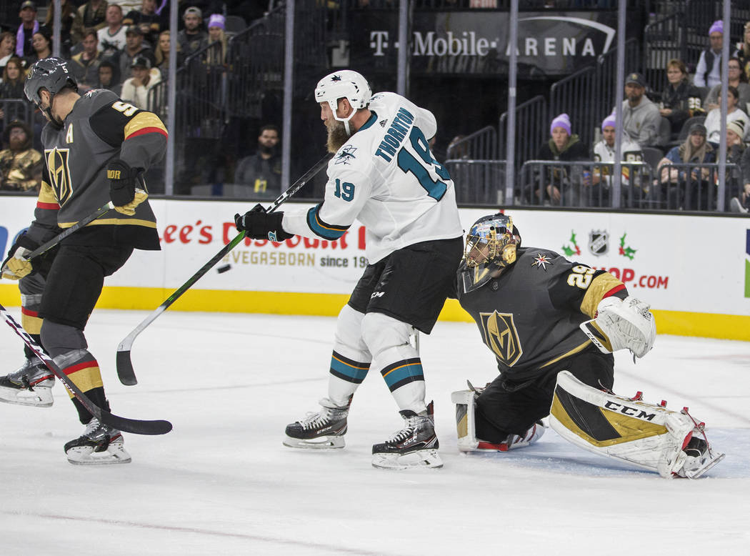 San Jose Sharks center Joe Thornton (19) tries to deflect the puck past Vegas Golden Knights go ...