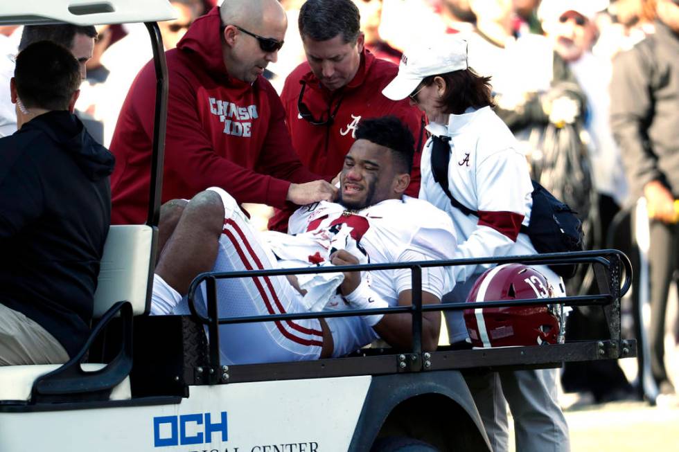 Alabama quarterback Tua Tagovailoa (13) is carted off the field after getting injured in the fi ...