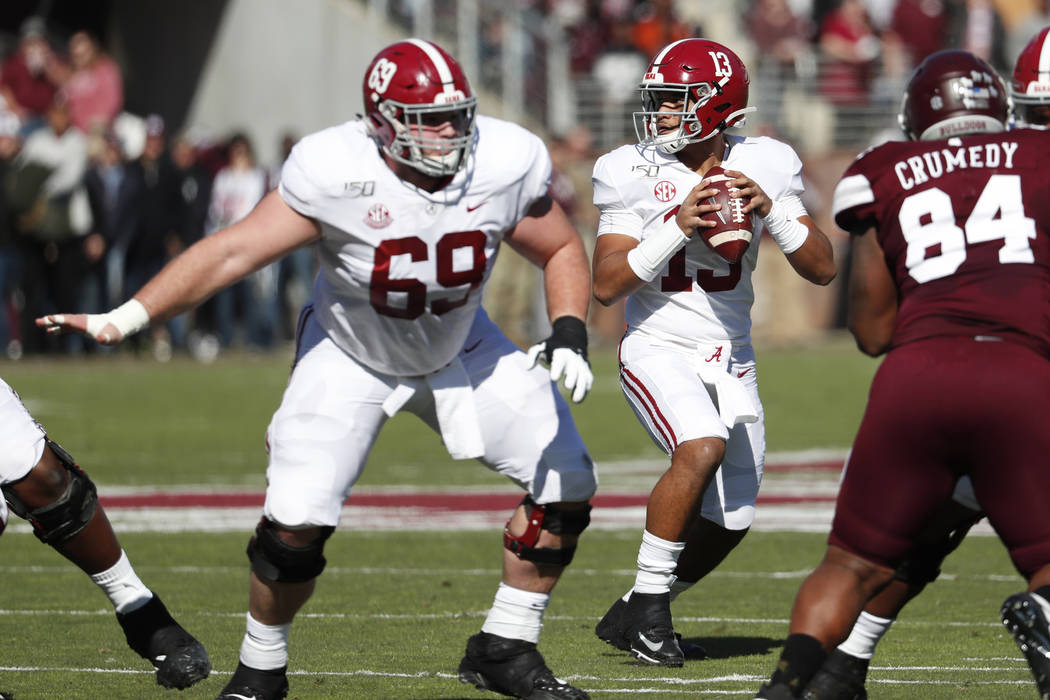 Alabama quarterback Tua Tagovailoa (13) sets up to pass behind the protection of offensive line ...