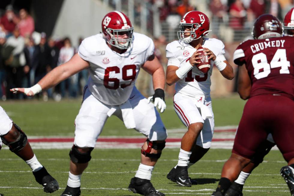 Alabama quarterback Tua Tagovailoa (13) sets up to pass behind the protection of offensive line ...