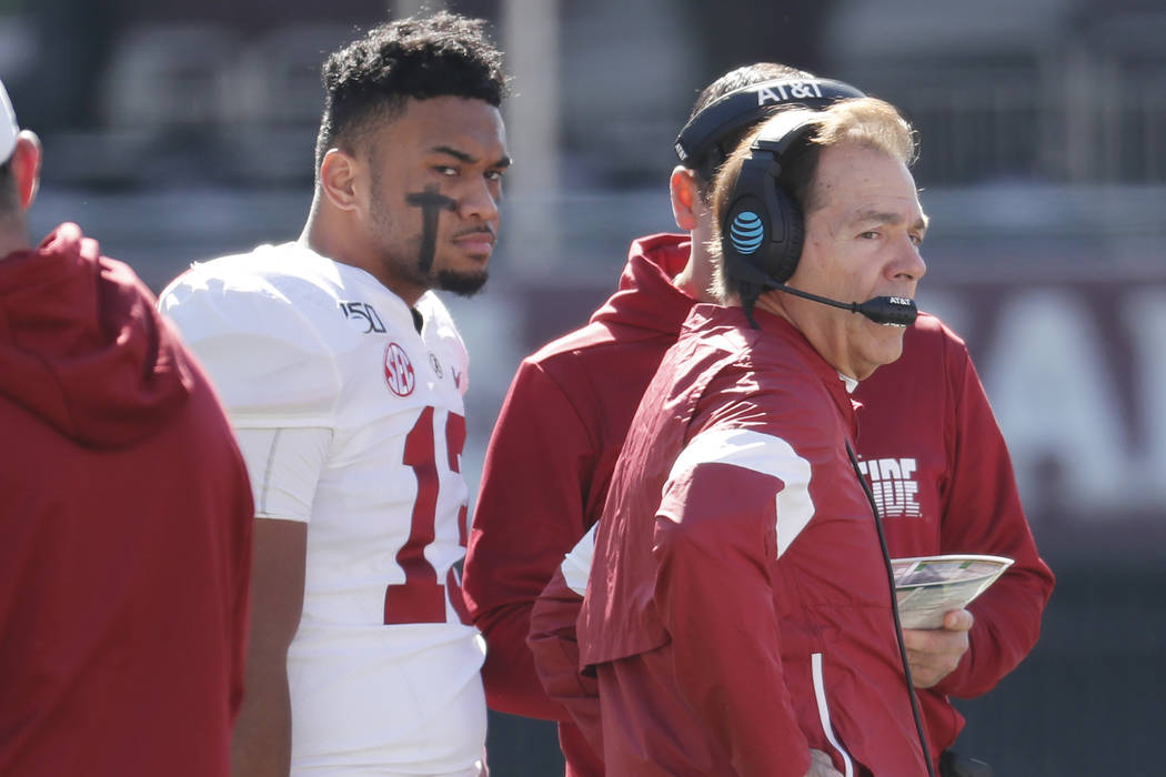 Alabama quarterback Tua Tagovailoa (13) listens to instructions from head coach Nick Saban duri ...