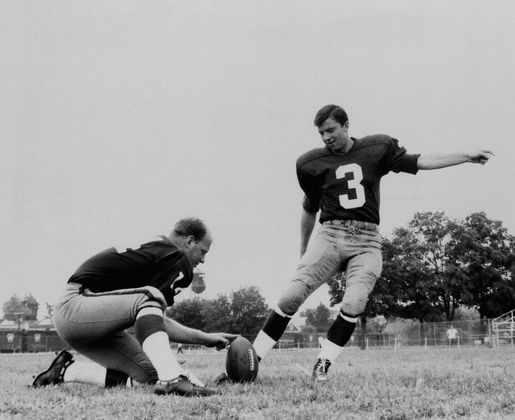 Football players Charlie Gogolak, Kicking with Dick Shine holding, 1966. (AP Photo).