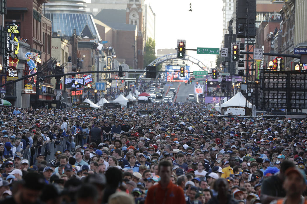 Fans watch ther main stage during the second round of the NFL football draft, Friday, April 26, ...