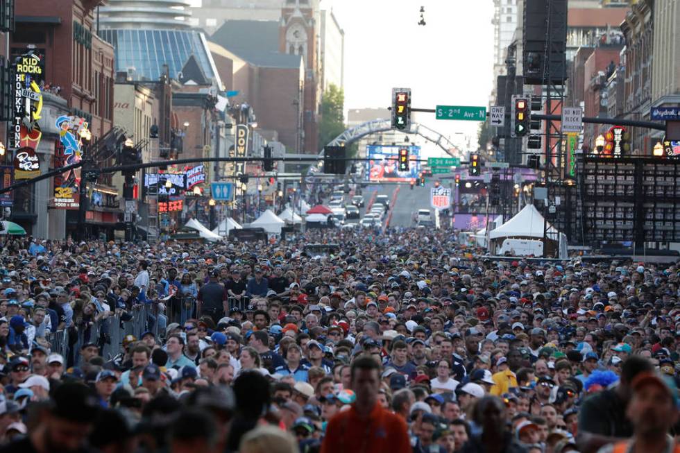 Fans watch ther main stage during the second round of the NFL football draft, Friday, April 26, ...