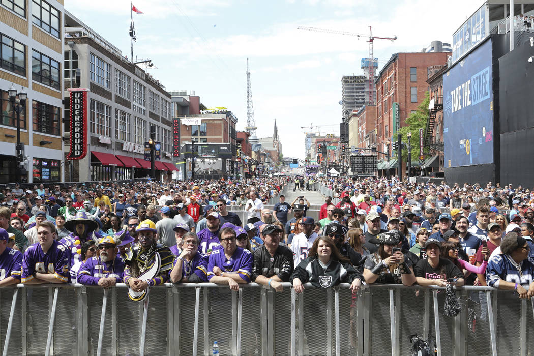 Fans line Broadway before the start of Day 3 of the NFL football draft, in Nashville, Tenn. on ...