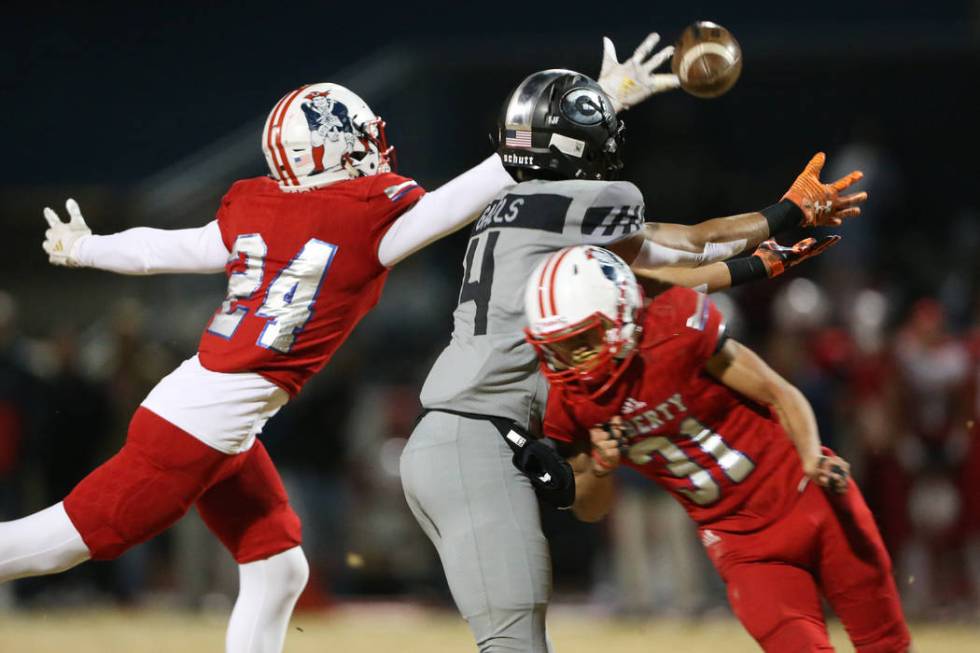 Liberty's Lehi Ausage (24), with Ikalewa Paaoao (31), breaks up a pass intended for Bishop Gorm ...