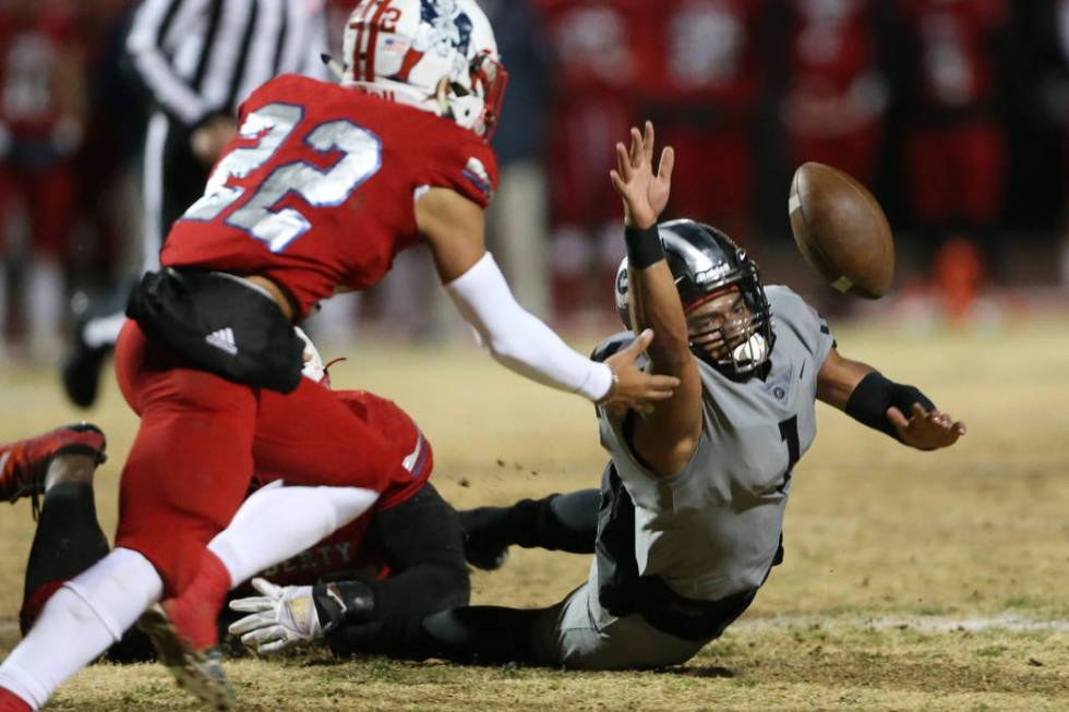 Bishop Gorman's Micah Bowens (1) fumbles the ball as Liberty's Trey Cain (22) reaches for the b ...