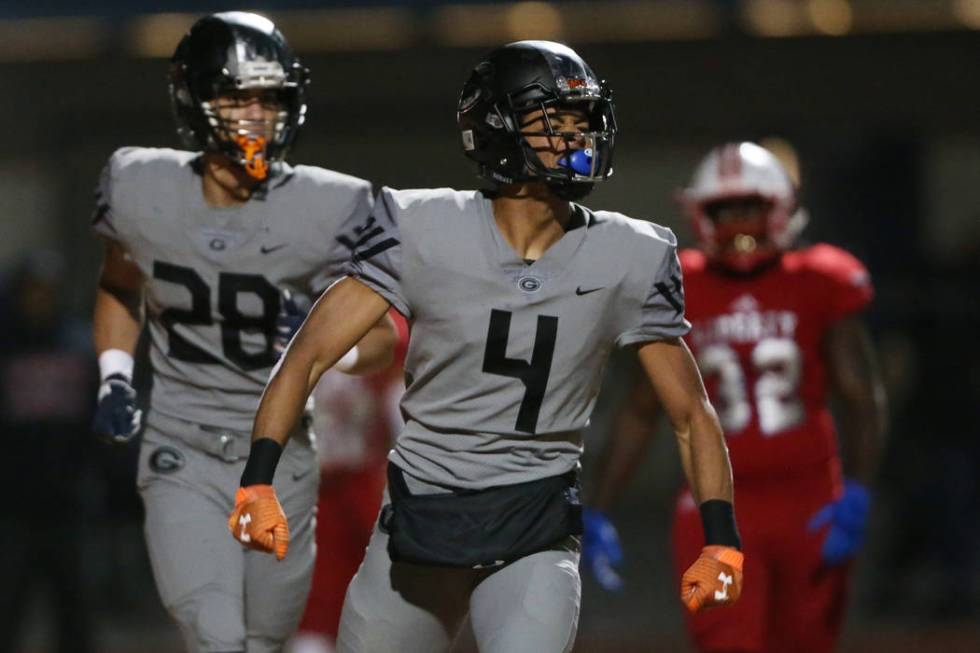 Bishop Gorman Rome Odunze (4) celebrates a touchdown catch, with Izaiah Halmos (28), in the fir ...