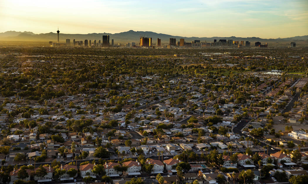 The sun rises on the city looking to the Strip from the west end on Wednesday, Oct. 16, 2019, i ...