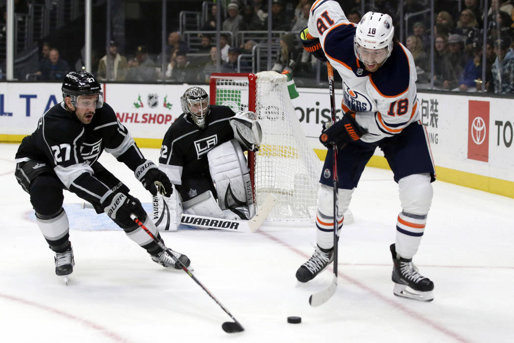 Edmonton Oilers left wing James Neal, right, controls the puck near Los Angeles Kings defensema ...