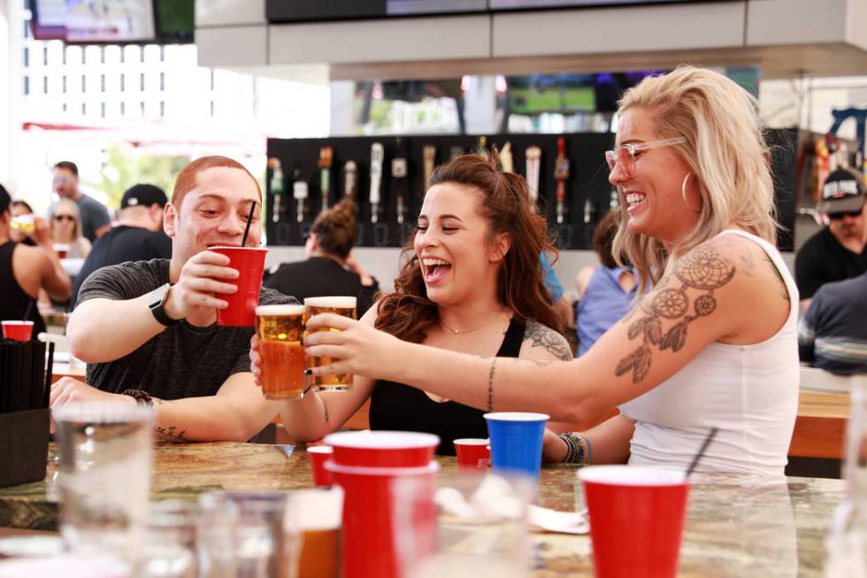 Scott Trimble, from left, Carissa Colligas and Jordan Rogers enjoy drinks at Beer Park at Paris ...