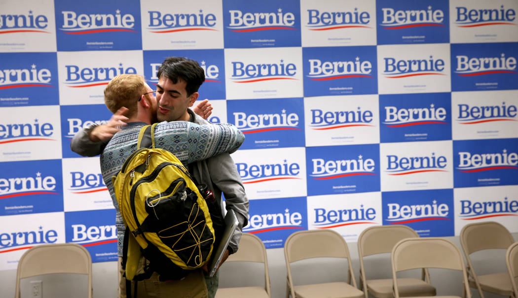 Field organizers Justin Coskey of Seattle, left, and Armon Goharbin of Los Angeles hug upon arr ...