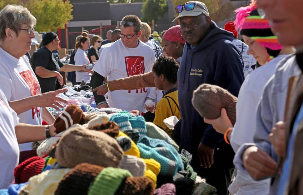 Crowds of people pick out hats and toiletry items at Project Homeless Connect at the Champion C ...