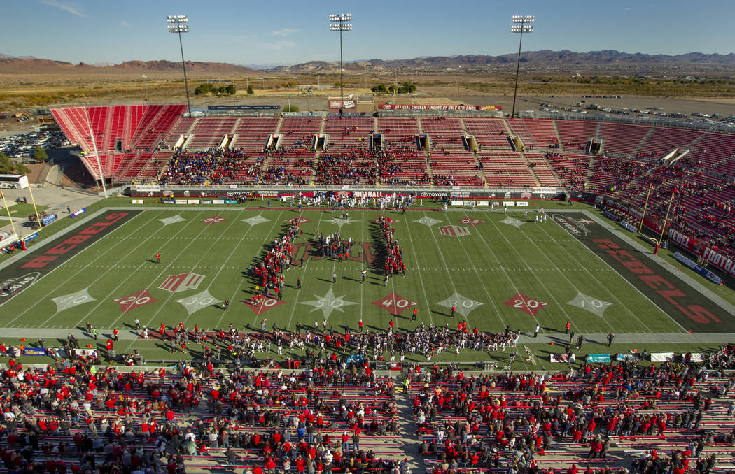 Former UNLV football players come together on the field for the coin toss versus the San Jose S ...