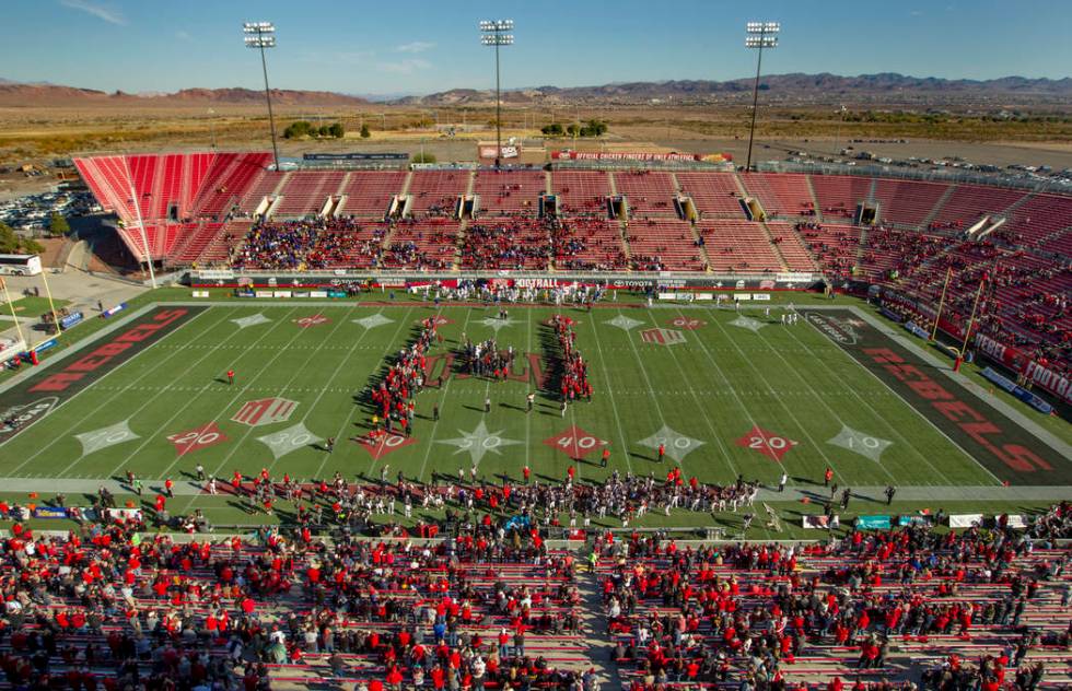 Former UNLV football players come together on the field for the coin toss versus the San Jose S ...