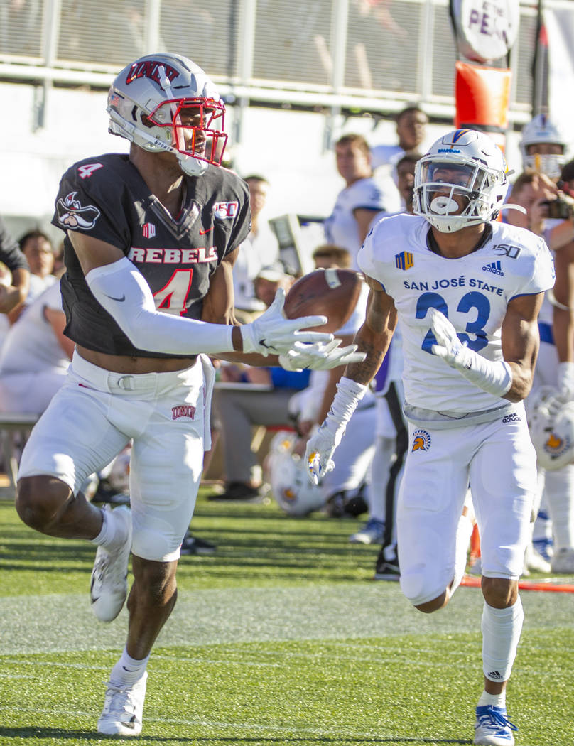 UNLV Rebels wide receiver Randal Grimes (4, left) hauls in a bobbled pass for a touchdown over ...