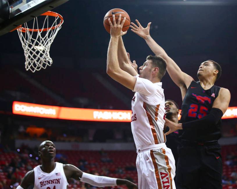 UNLV's Vitaliy Shibel (22) goes to the basket past Southern Methodist's Ethan Chargois (25) dur ...