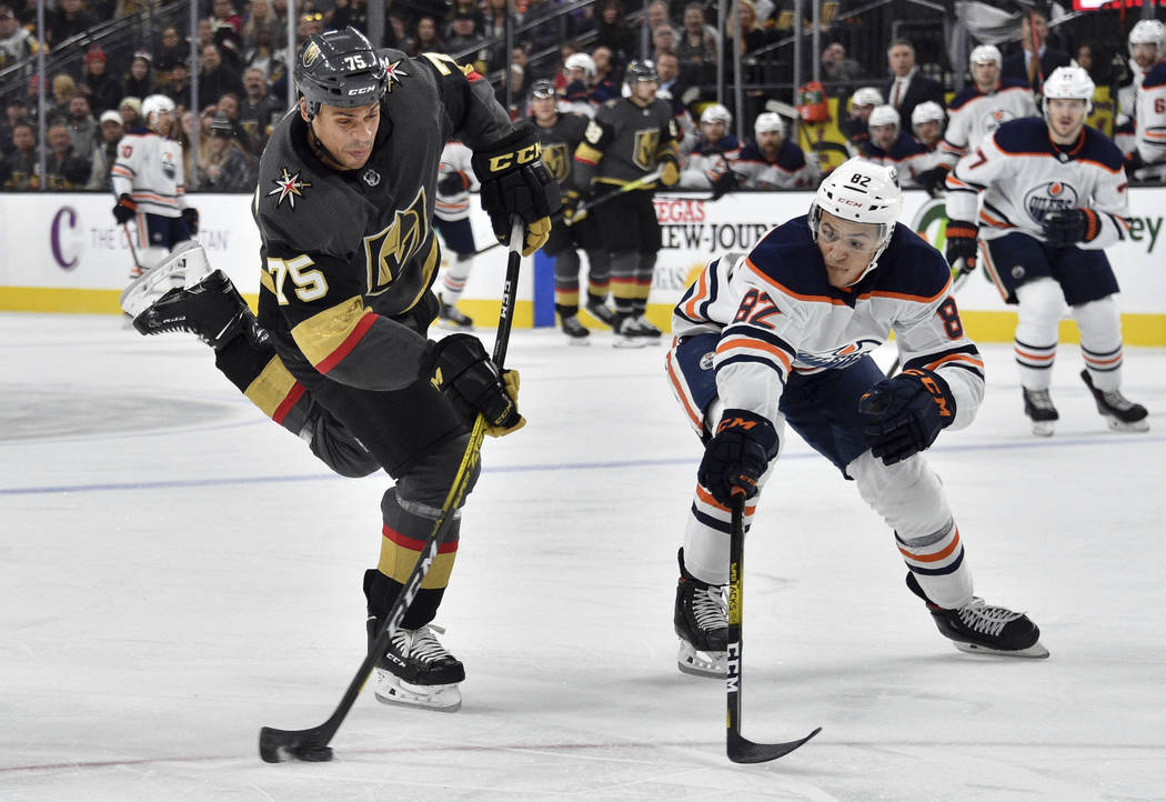 Vegas Golden Knights right wing Ryan Reaves (75) shoots next to Edmonton Oilers defenseman Cale ...