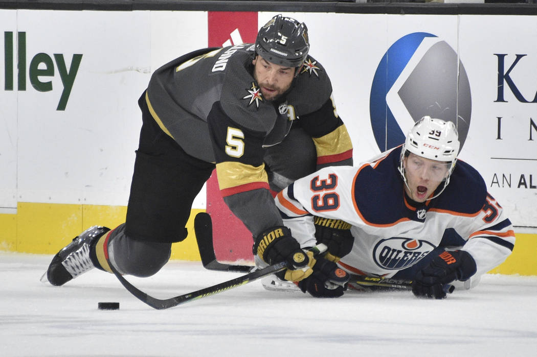 Vegas Golden Knights defenseman Deryk Engelland (5) and Edmonton Oilers right wing Alex Chiasso ...