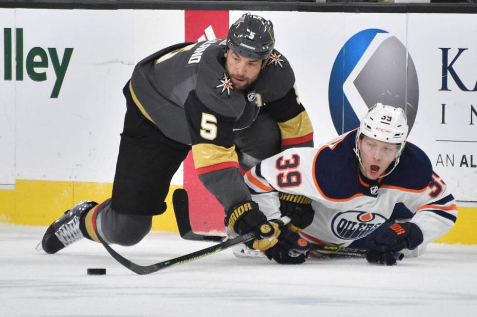 Vegas Golden Knights defenseman Deryk Engelland (5) and Edmonton Oilers right wing Alex Chiasso ...