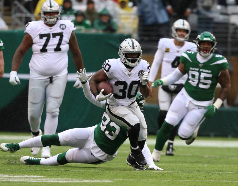 Oakland Raiders running back Jalen Richard (30) runs past New York Jets linebacker Tarell Basha ...