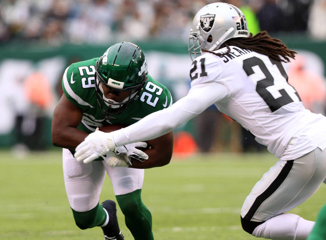 New York Jets running back Bilal Powell (29) runs with the football as Oakland Raiders free saf ...