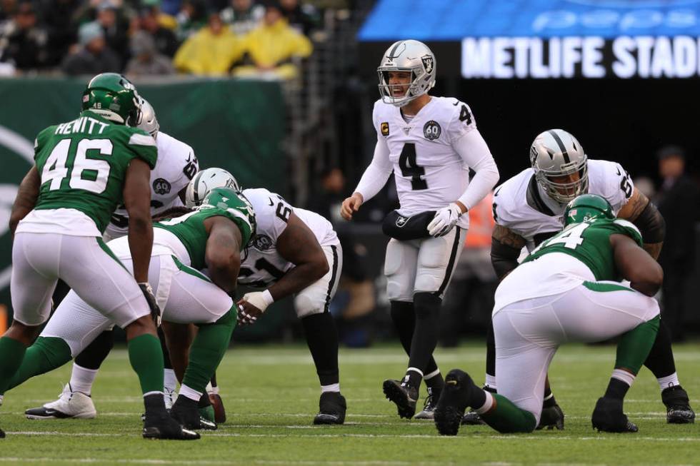 Oakland Raiders quarterback Derek Carr (4) calls a play at the line of scrimmage during the fir ...