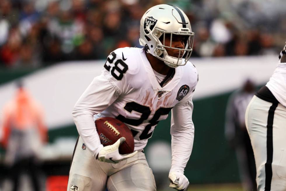 Oakland Raiders running back Josh Jacobs (28) runs with the football during the first half of a ...