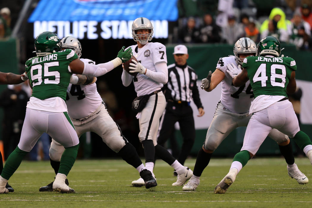 Oakland Raiders quarterback Mike Glennon (7) prepares to throw the football as offensive guard ...