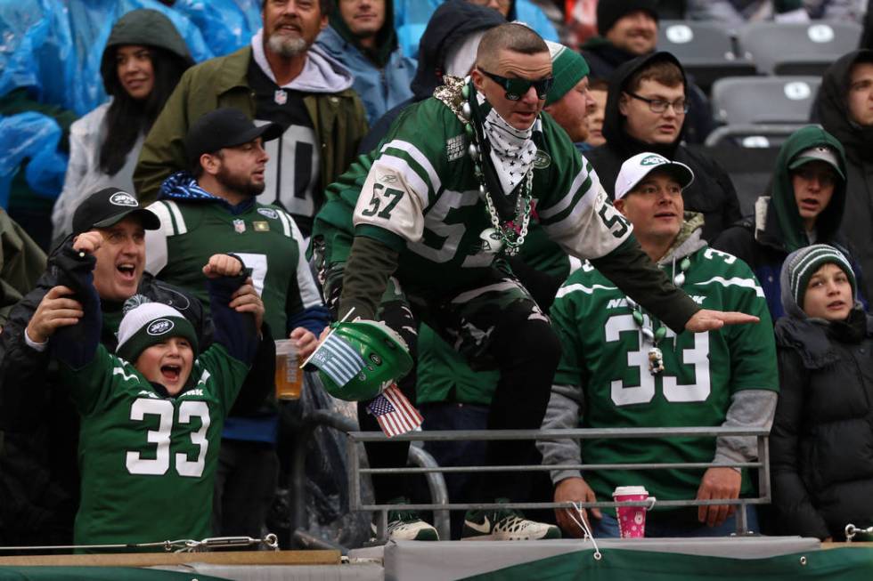 A New York Jets fan stand on the edge of the stands during the first half of an NFL game agains ...