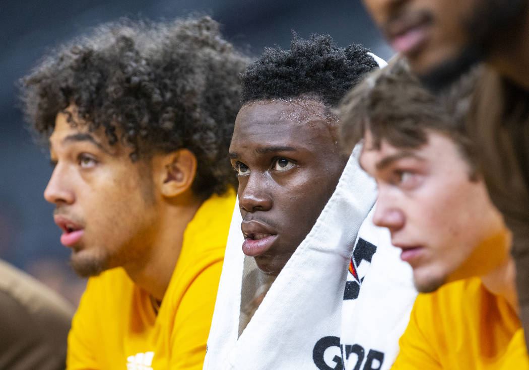 Wyoming guard A.J. Banks (2, center) watches the action with teammates on the bench versus Colo ...