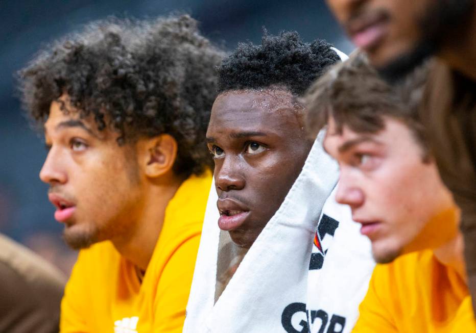 Wyoming guard A.J. Banks (2, center) watches the action with teammates on the bench versus Colo ...