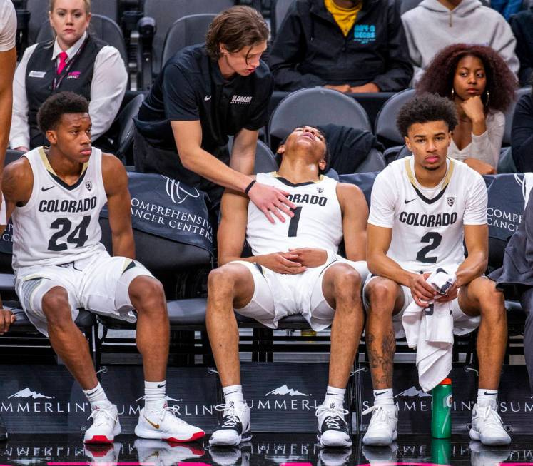 Colorado guard Tyler Bey (1, center) is tapped out on the bench during a rest versus Wyoming du ...