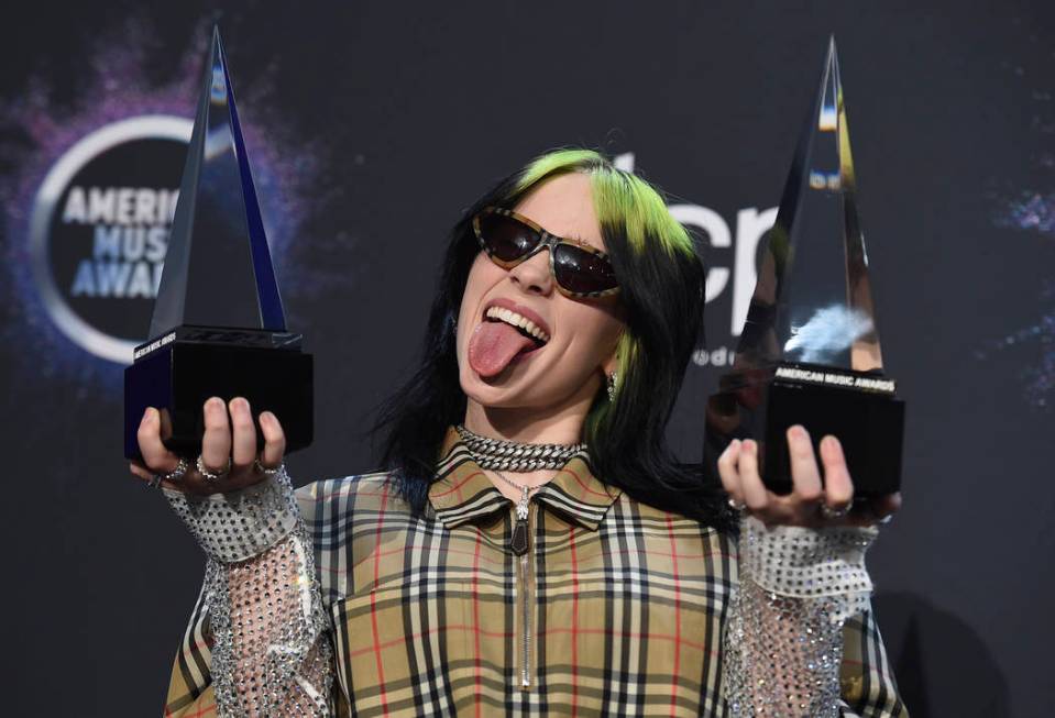 Billie Eilish poses in the press room with the award for new artist of the year and favorite al ...