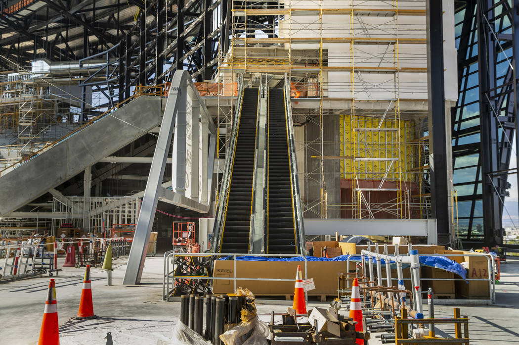 The upper concourse with escalators and Strip view during an Allegiant Stadium tour on Monday, ...