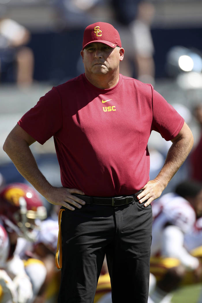 Southern California head coach Clay Helton watches his players warm up before a NCAA college fo ...