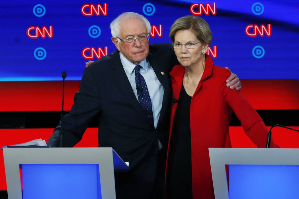 Sen. Bernie Sanders, I-Vt., and Sen. Elizabeth Warren, D-Mass., embrace after the first of two ...