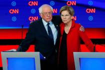 Sen. Bernie Sanders, I-Vt., and Sen. Elizabeth Warren, D-Mass., embrace after the first of two ...