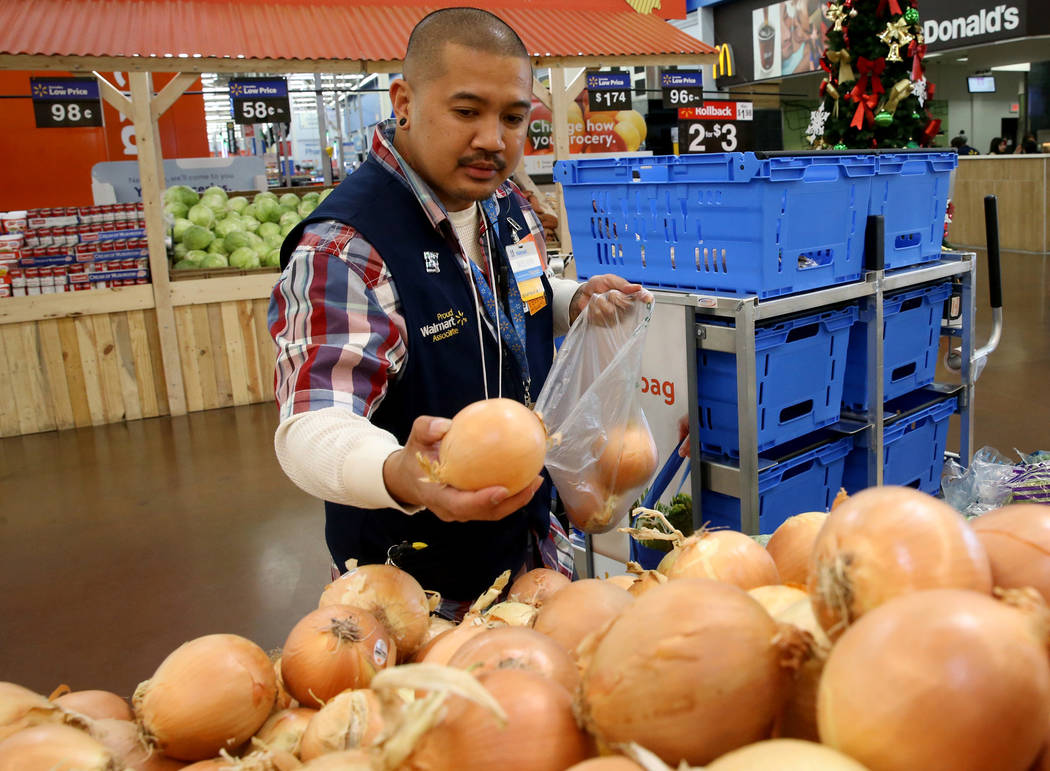 Personal shopper Melvin Oasay fills customer orders for pickup at Walmart at 7200 Arroyo Crossi ...