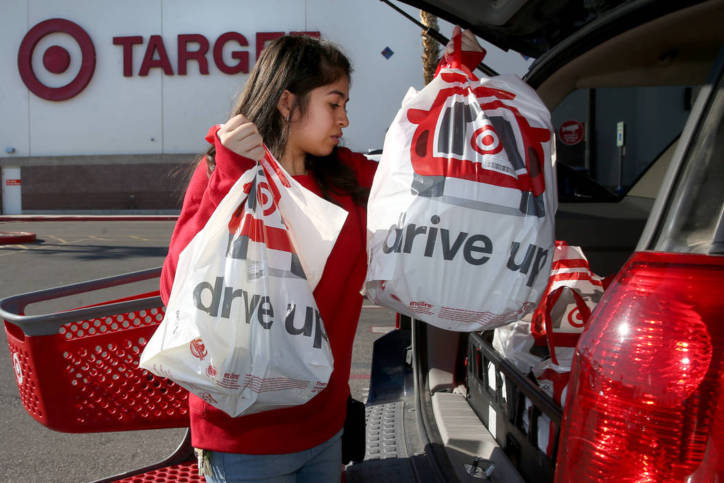 Guest service advocate Jessica De La Cruz delivers a curbside pickup order at Target at 9725 S. ...