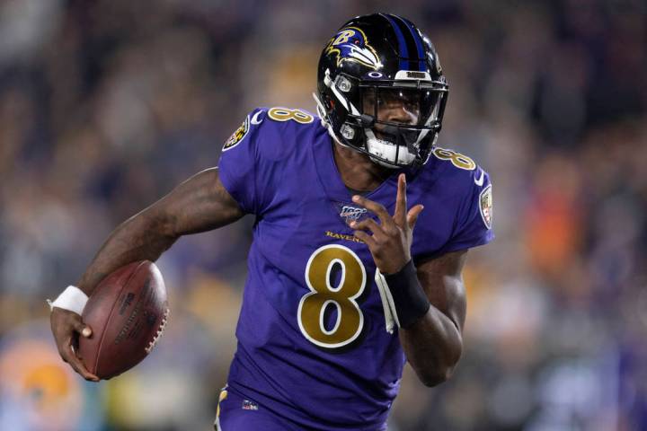 Baltimore Ravens quarterback Lamar Jackson runs against the Los Angeles Rams during the first h ...