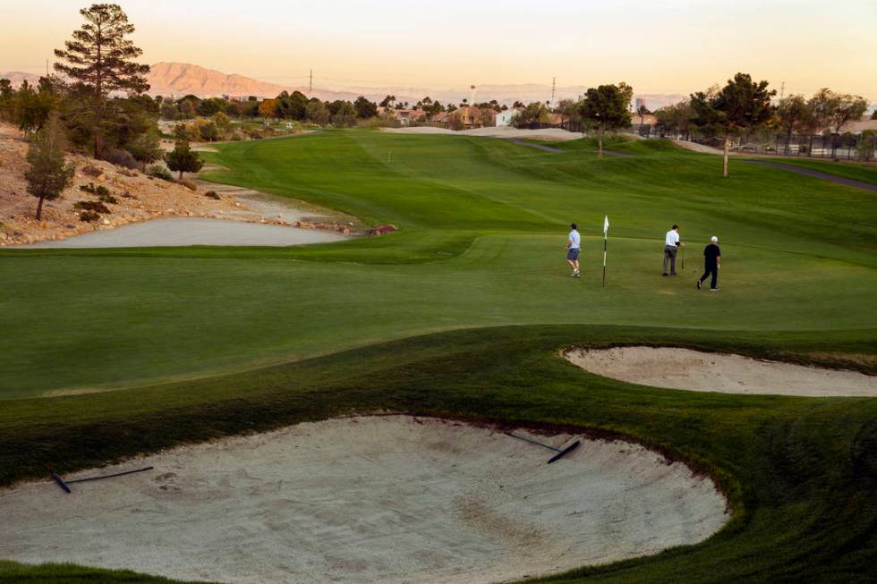 Golfers putt at hole # 18 on the Palm Course at the Angel Park Golf Club on Tuesday, Nov. 12, 2 ...