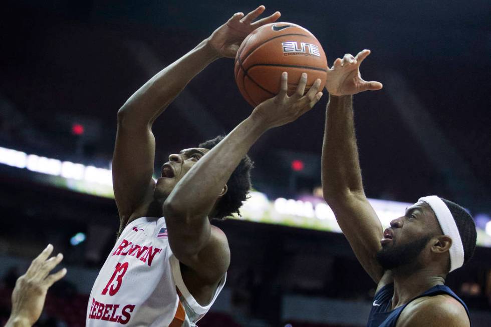 UNLV Rebels guard Bryce Hamilton (13) drives past Jackson State Tigers guard Lemmie Howard (21) ...