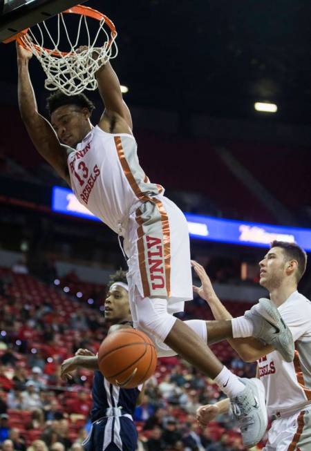 UNLV Rebels guard Bryce Hamilton (13) dunks over Jackson State Tigers guard Venjie Wallis (0) i ...