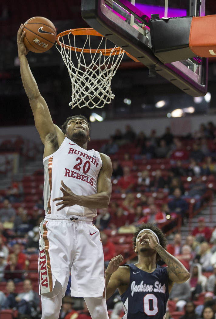 UNLV Rebels forward Nick Blair (20) drives baseline past Jackson State Tigers guard Venjie Wall ...