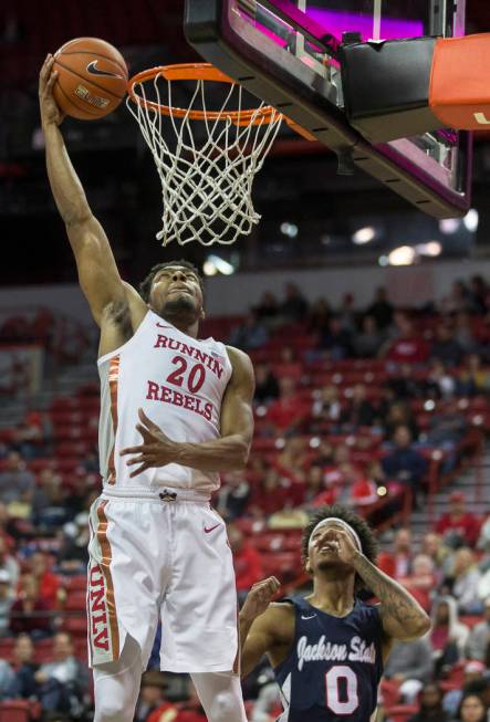 UNLV Rebels forward Nick Blair (20) drives baseline past Jackson State Tigers guard Venjie Wall ...