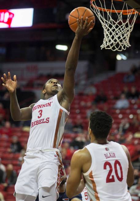 UNLV Rebels guard Amauri Hardy (3) slashes to the basket with UNLV Rebels forward Nick Blair (2 ...