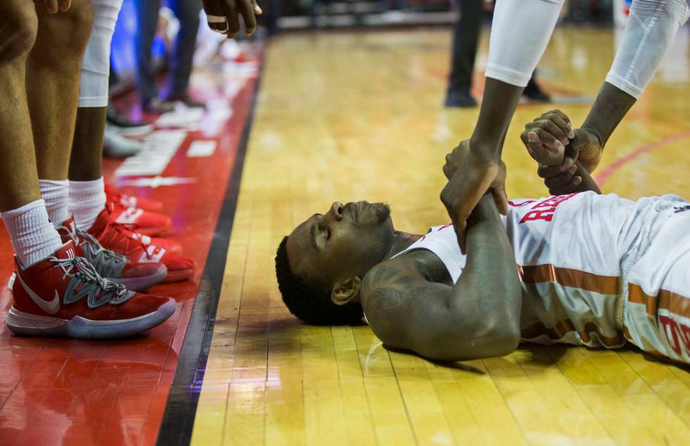 UNLV Rebels guard Amauri Hardy (3) is helped to his feet by a teammate in the second half durin ...