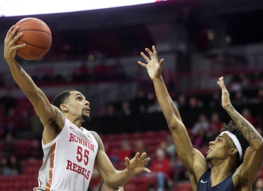 UNLV Rebels guard Elijah Mitrou-Long (55) drives over Jackson State Tigers guard Venjie Wallis ...